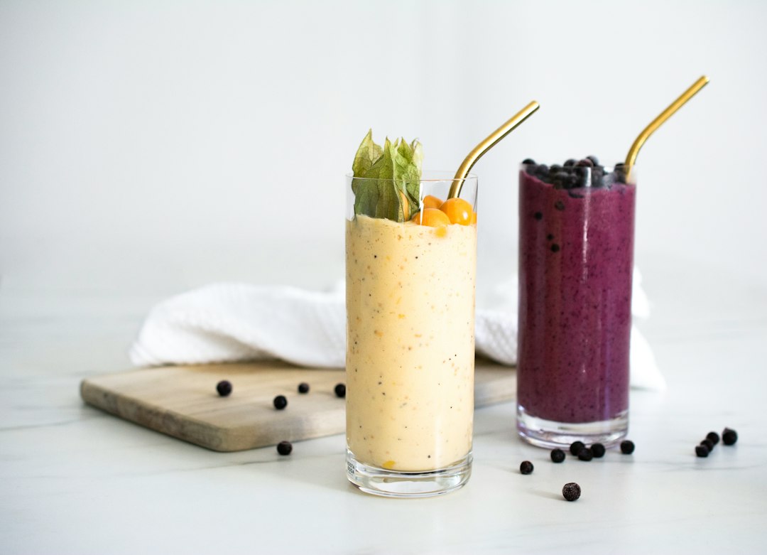 Smoothie Bowl vs Drinkable Smoothie: Satiety Science & Weight Loss Impact 1 Side-by-side comparison of a thick berry smoothie bowl with toppings and a green drinkable smoothie in a tall glass.